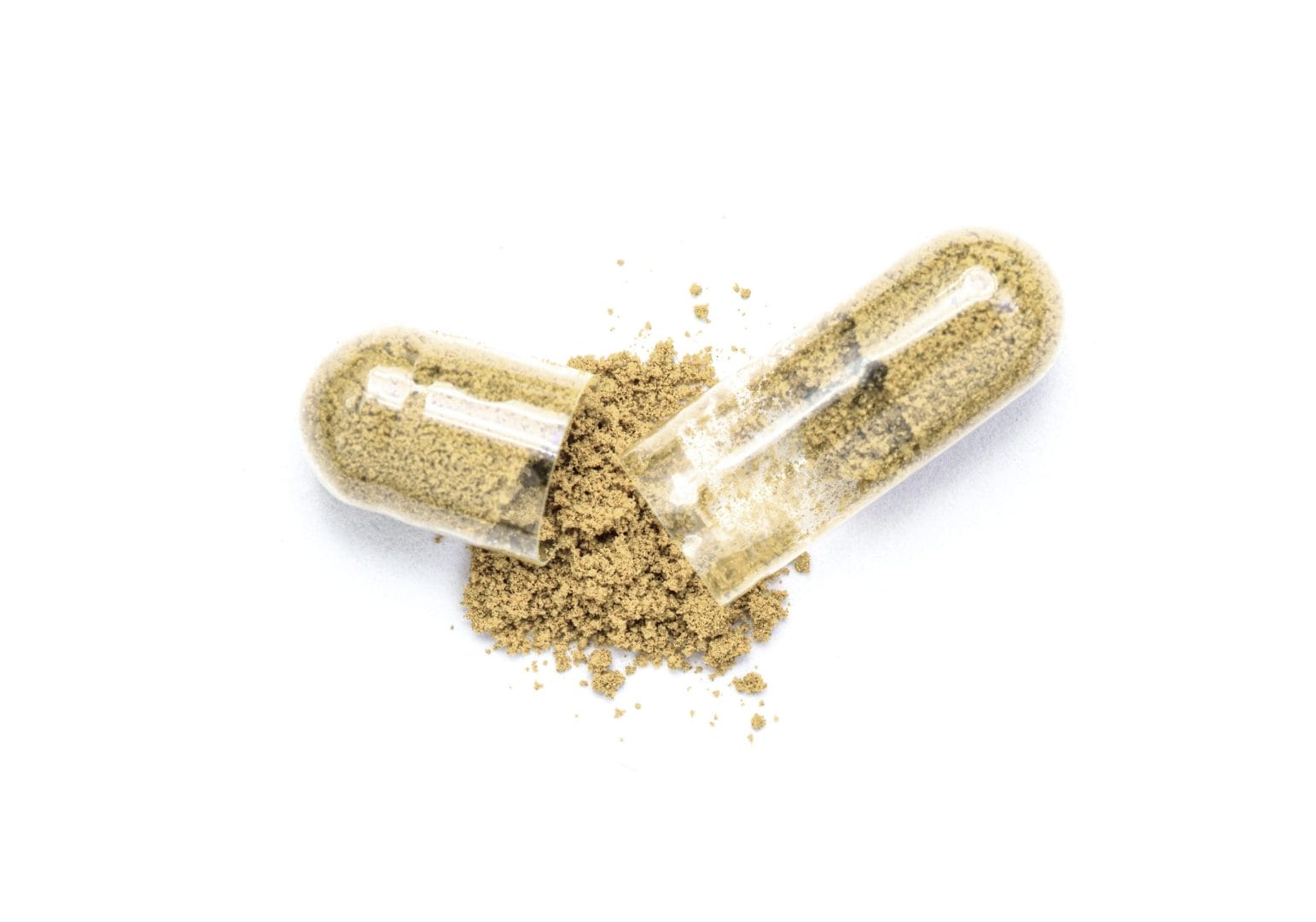 Open clear supplement capsule with herbal powder spilled on white background.